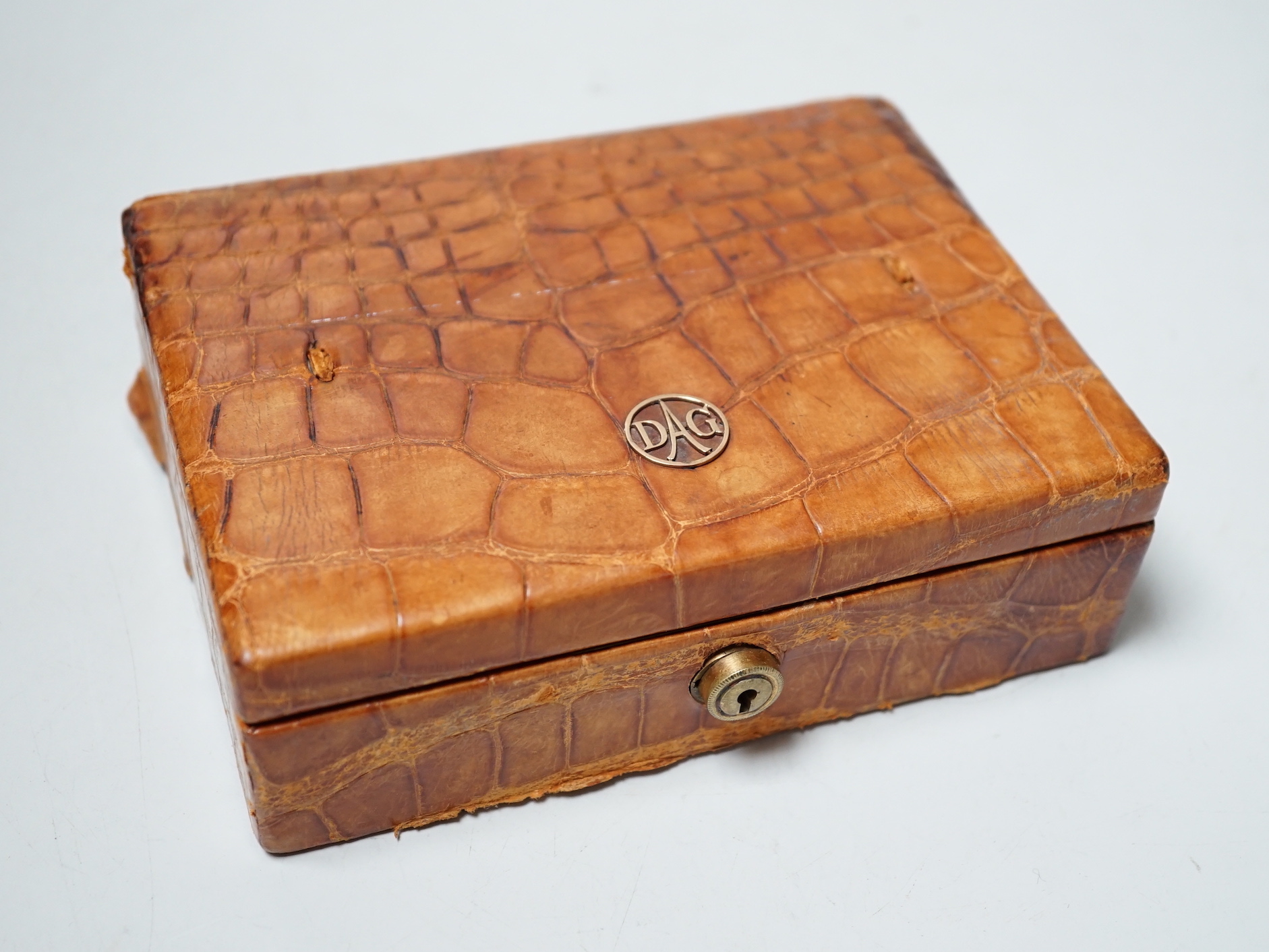 A crocodile jewellery box and a cameo brooch.